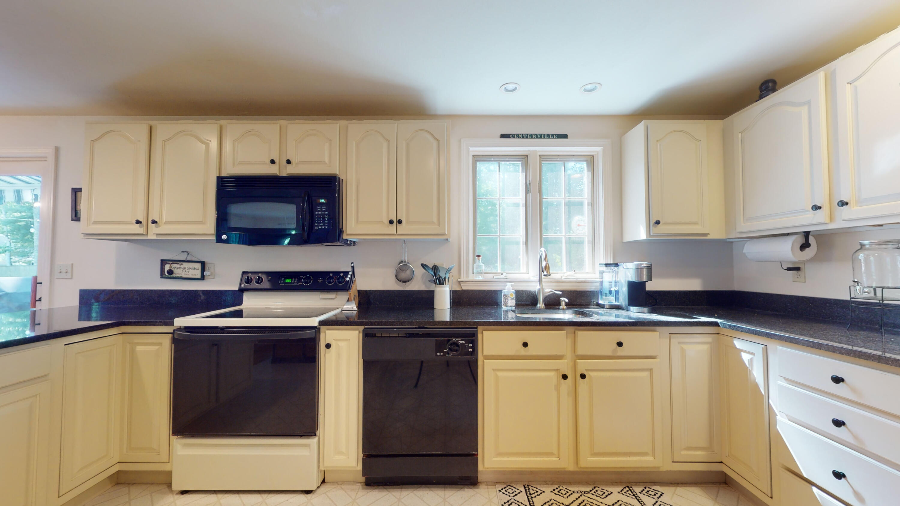 9 Rainbow Drive Centerville, MA 02632 - Photo 14 of 49 a kitchen with stainless steel appliances granite countertop a stove a sink dishwasher and a microwave oven with cabinets