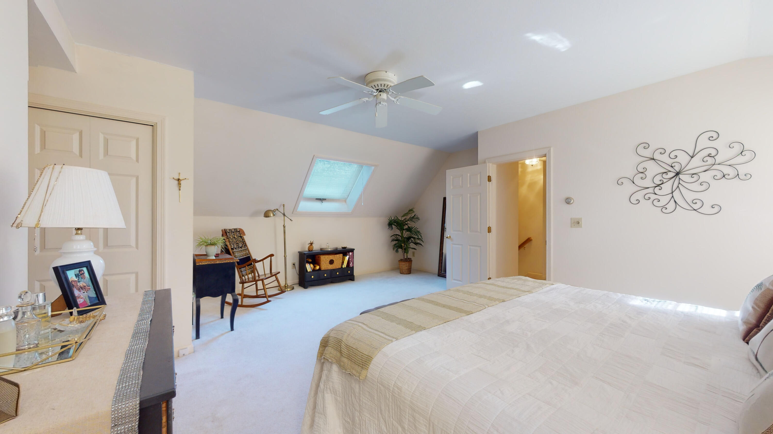 9 Rainbow Drive Centerville, MA 02632 - Photo 22 of 49 a spacious bedroom with a bed and a chandelier