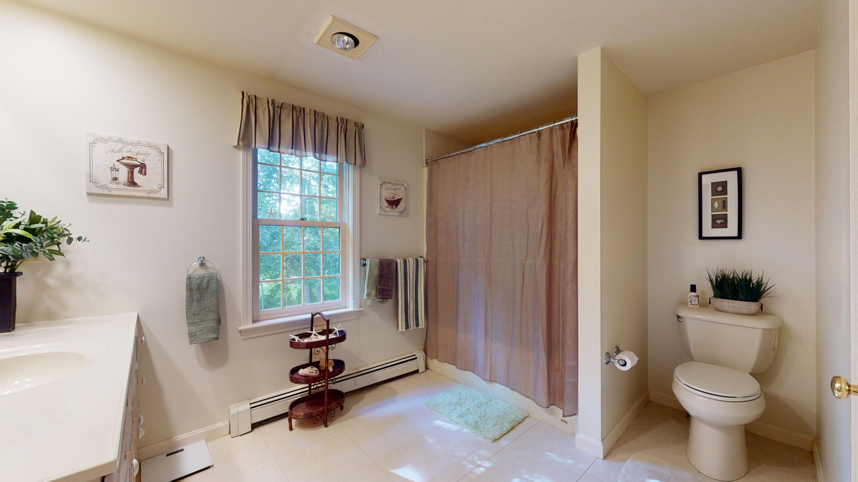 9 Rainbow Drive Centerville, MA 02632 - Photo 24 of 49 a living room with furniture a window and a potted plant