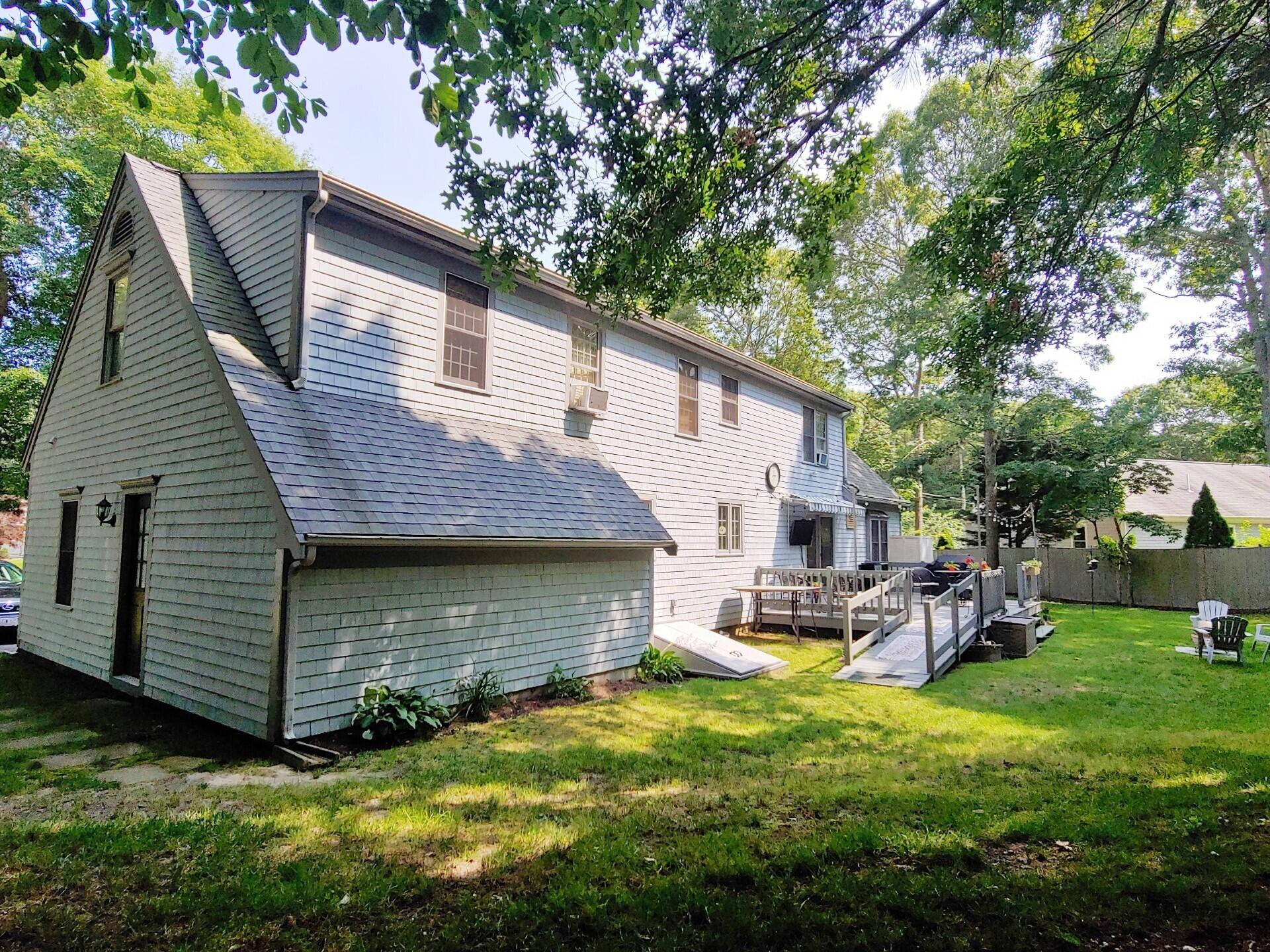 9 Rainbow Drive Centerville, MA 02632 - Photo 34 of 49 a view of backyard of house with wooden deck and seating space