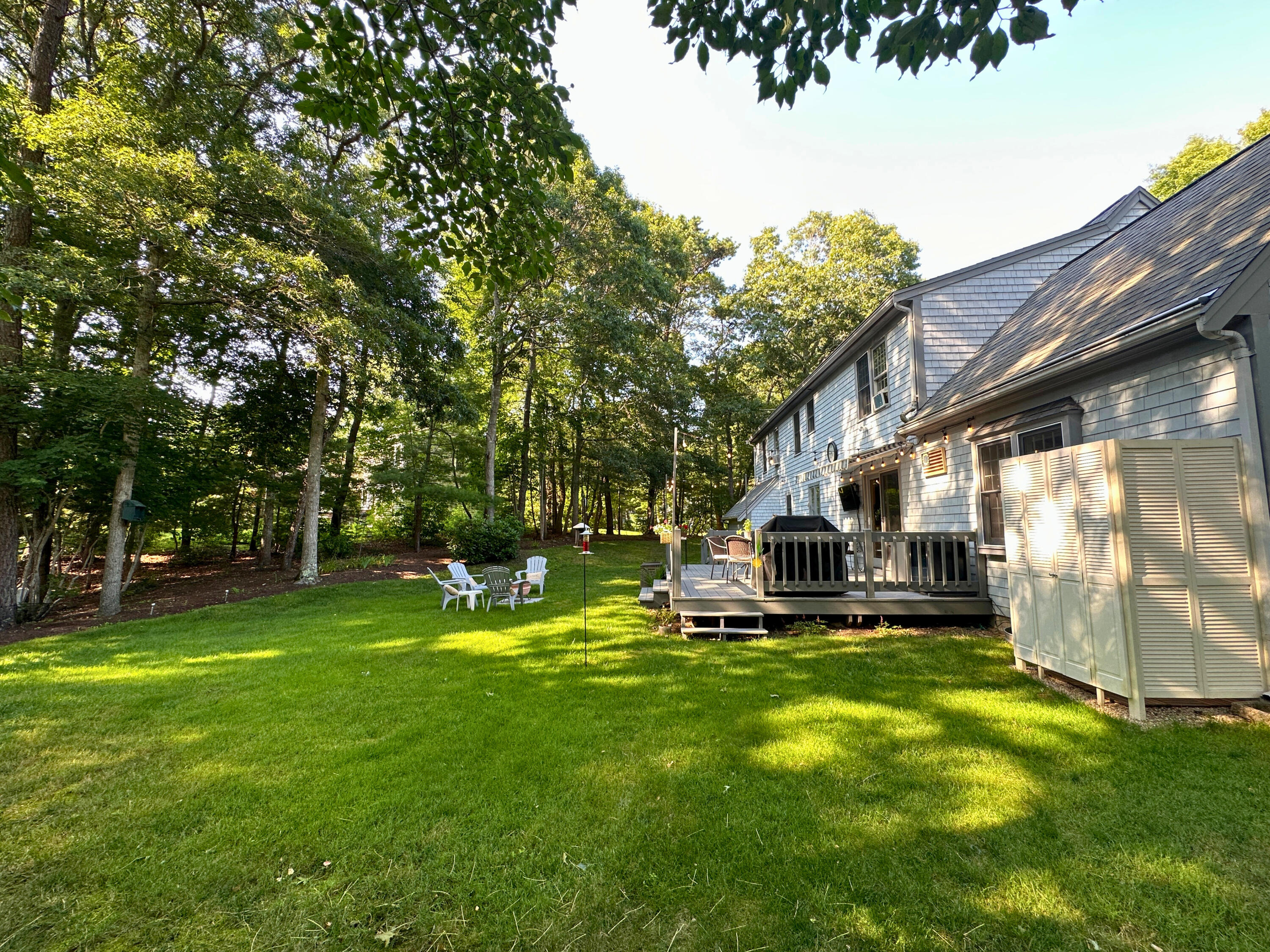 9 Rainbow Drive Centerville, MA 02632 - Photo 37 of 49 a view of a house with a big yard and sitting area
