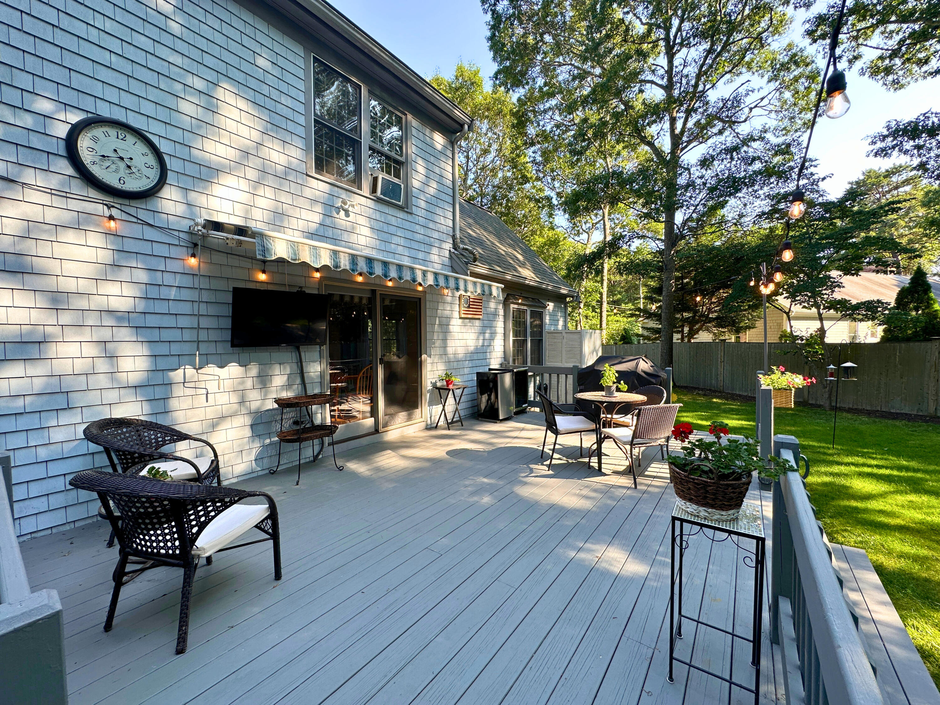 9 Rainbow Drive Centerville, MA 02632 - Photo 38 of 49 a view of a deck with table and chairs with wooden floor and fence