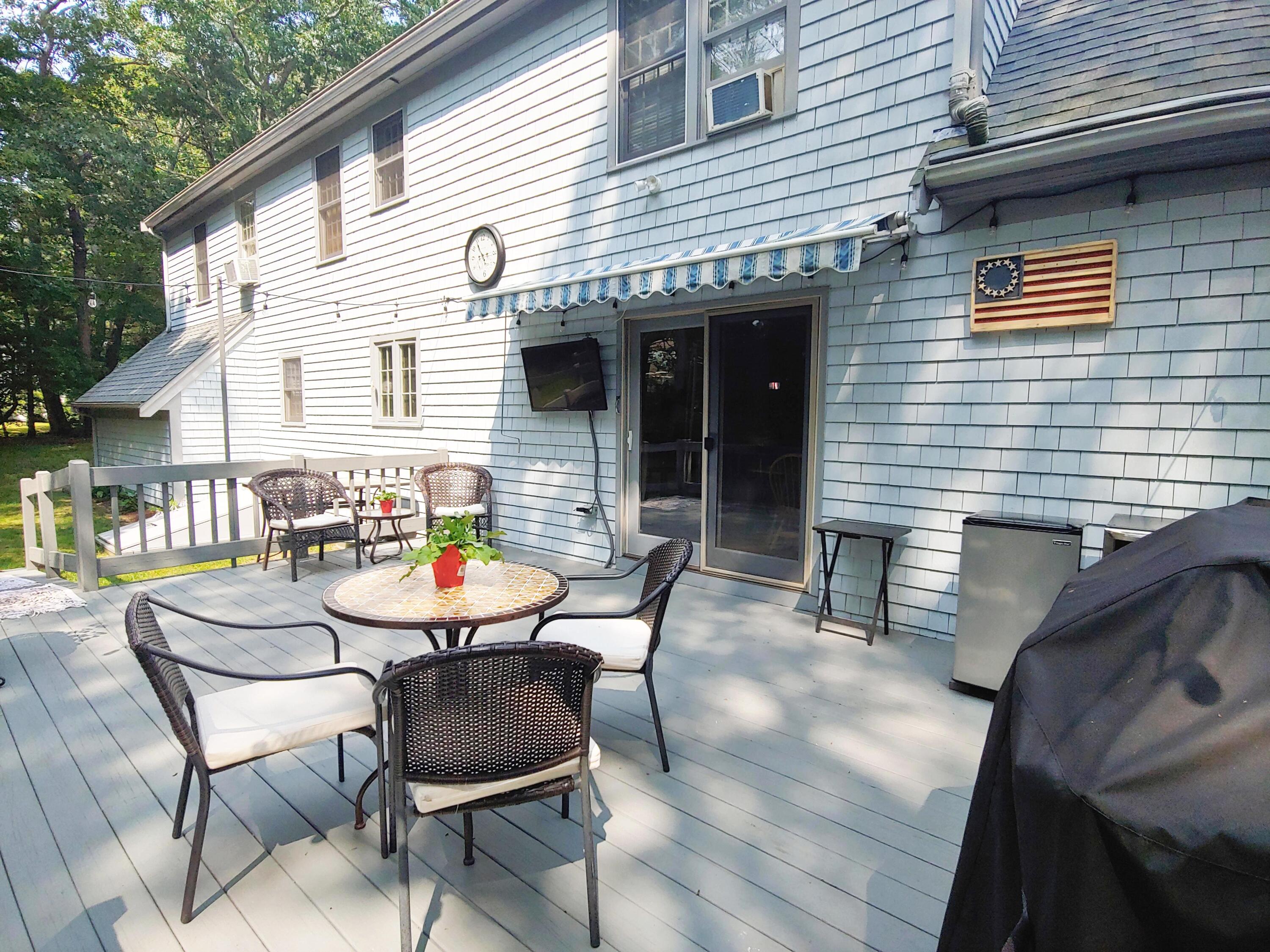 9 Rainbow Drive Centerville, MA 02632 - Photo 39 of 49 a balcony with table and chairs and potted plants