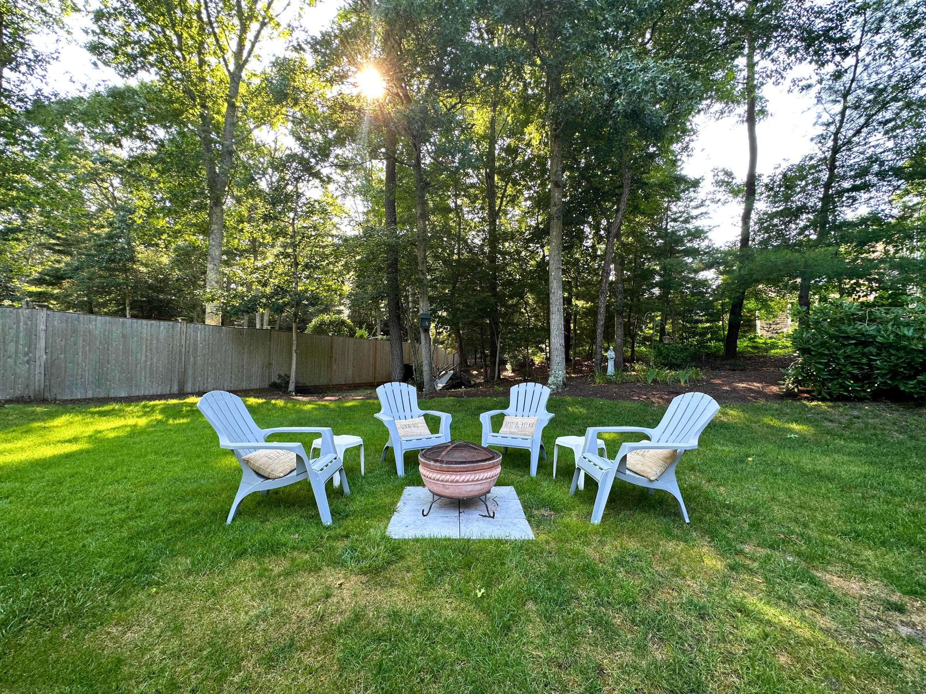 9 Rainbow Drive Centerville, MA 02632 - Photo 41 of 49 a chairs and a table in a backyard