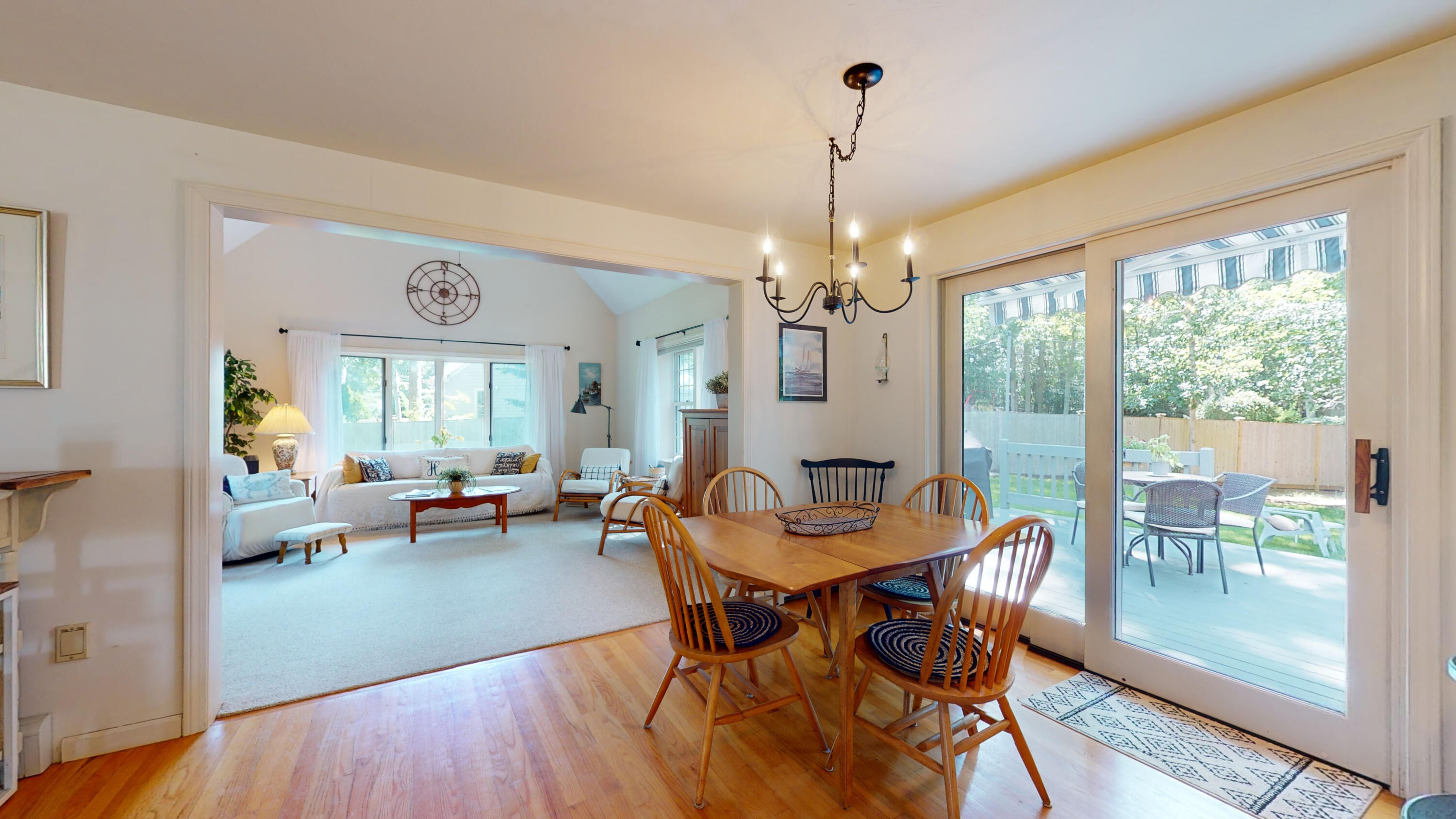 9 Rainbow Drive Centerville, MA 02632 - Photo 7 of 49 a view of a dining room with furniture wooden floor and a chandelier