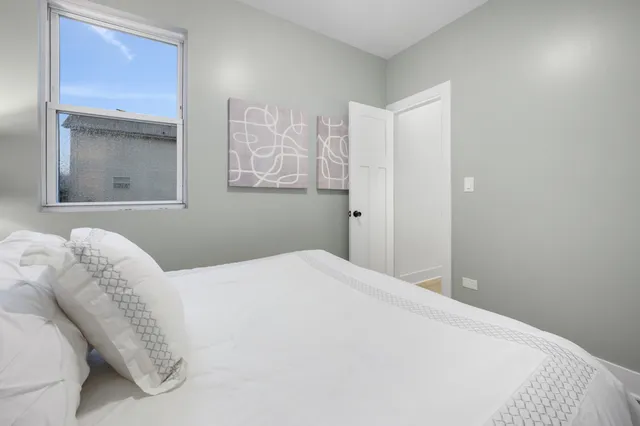 a bedroom with a bed and a window