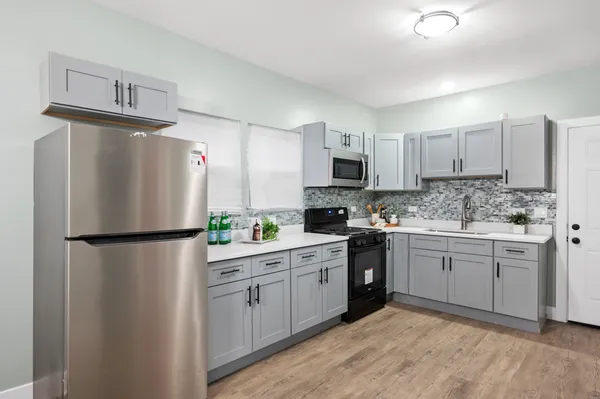 a white refrigerator freezer sitting inside of a kitchen