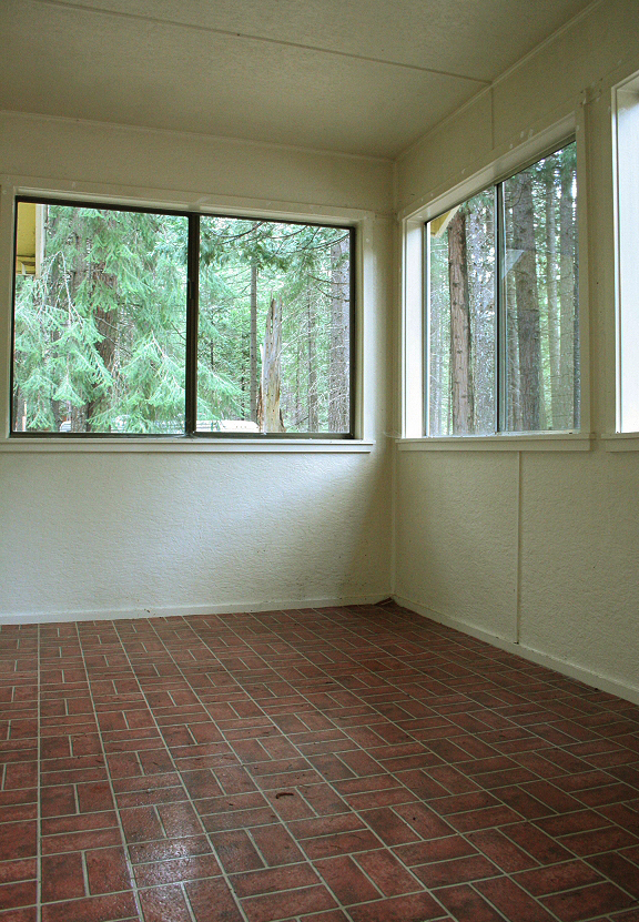 9455 Thatcher Mill Road Shingletown, CA 96088 - Photo 3 of 22 an empty room with wooden floor and windows