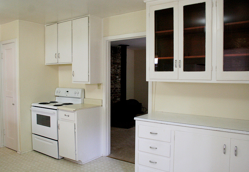 9455 Thatcher Mill Road Shingletown, CA 96088 - Photo 7 of 22 a kitchen with granite countertop white cabinets and white appliances