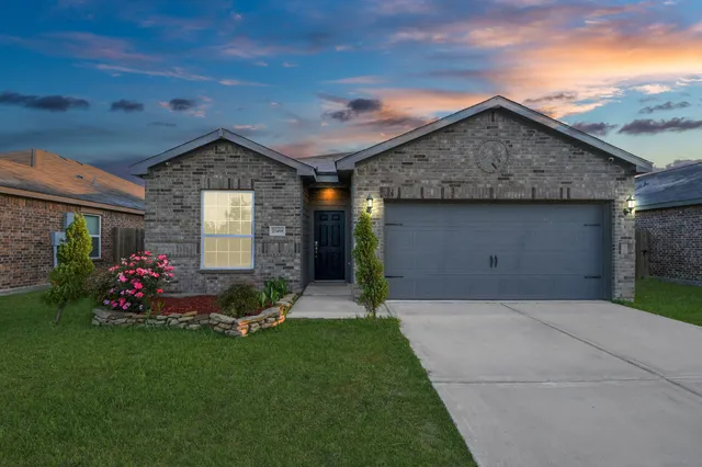a front view of house with a garden