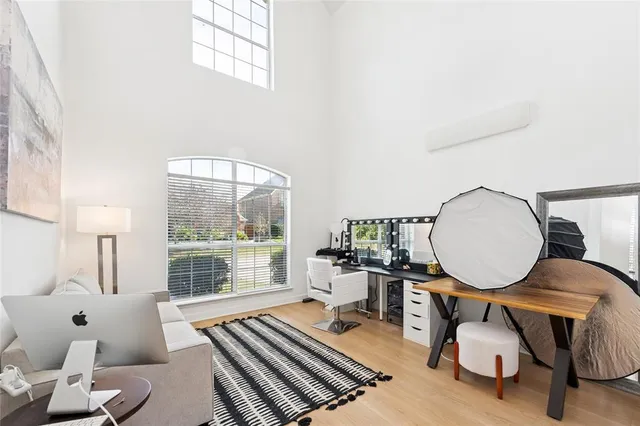 a living room with furniture a table and a large window