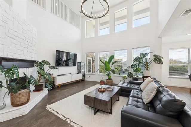 a living room with furniture fireplace and a potted plant
