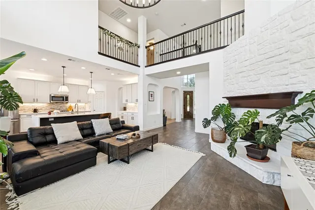 a living room with furniture and a chandelier