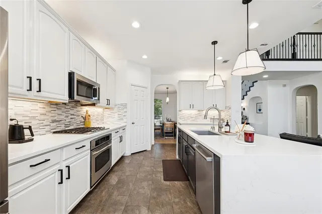a kitchen with a sink stove and microwave