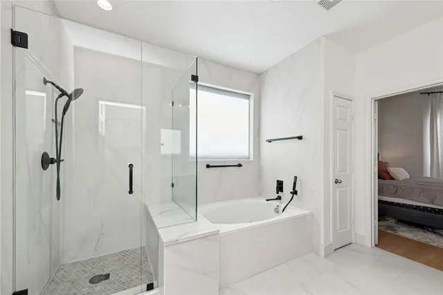 a white bath tub sitting next to a shower