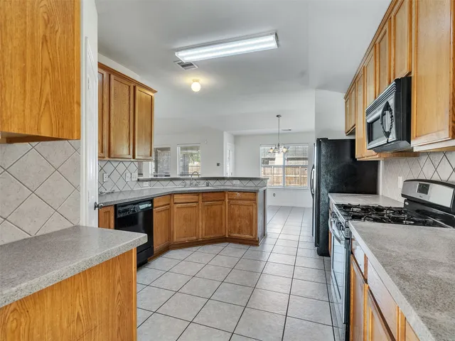 a kitchen with granite countertop cabinets stainless steel appliances and wooden cabinets