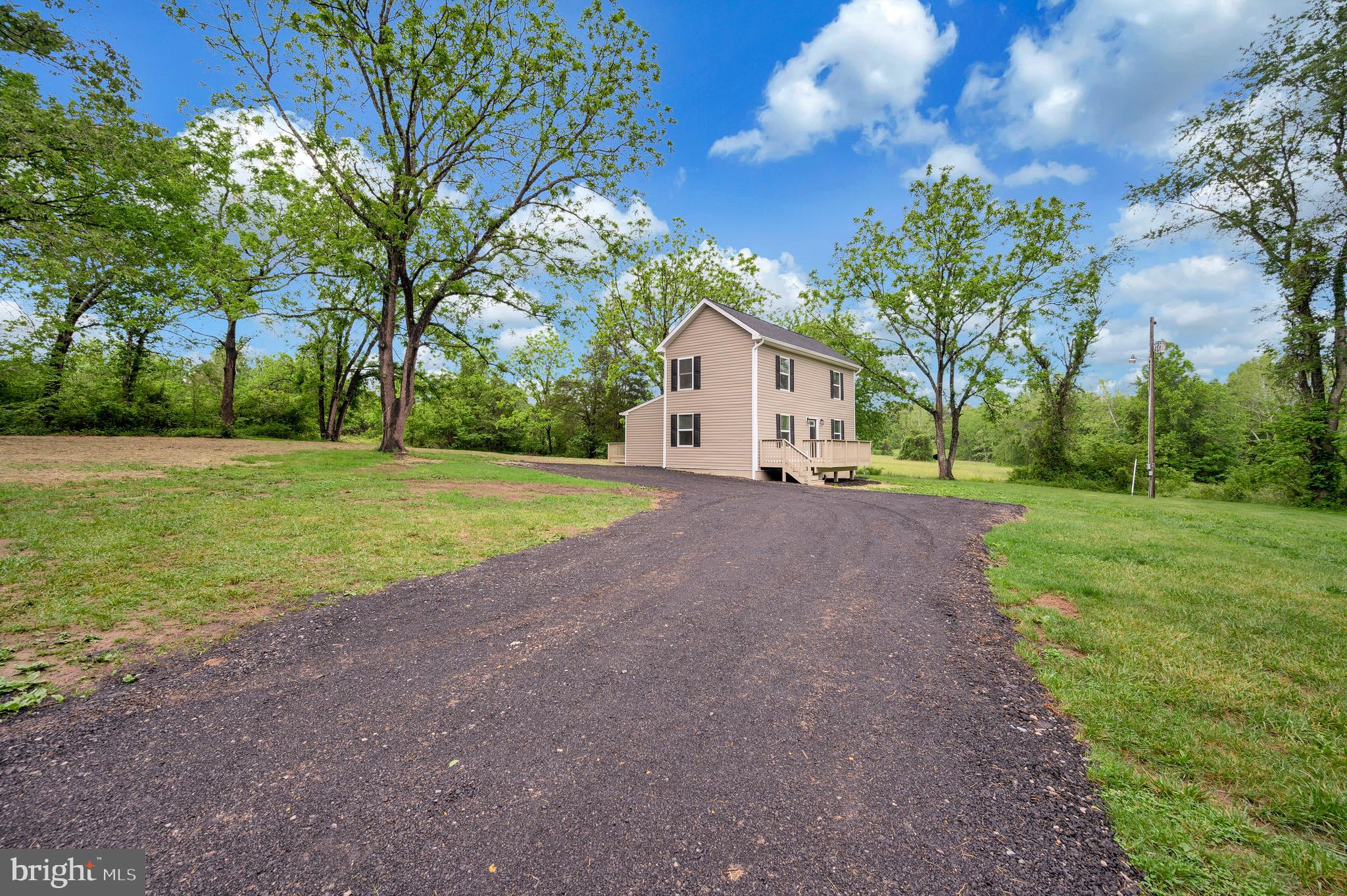 14169 Silver Hill Road Sumerduck, VA 22742 - Photo 32 of 40 a view of a house with a big yard and large trees