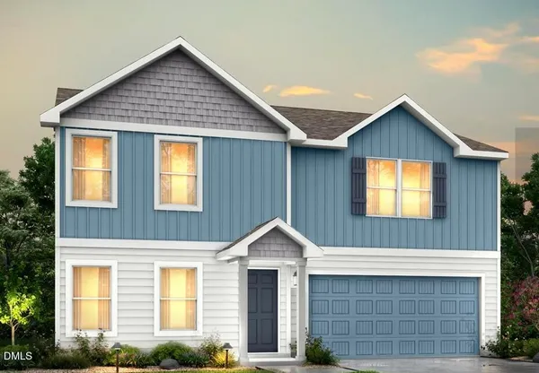a front view of a house with garage and yard