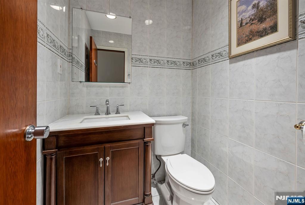 84 Bogerts Mill Road Harrington Park, NJ 07640 - Photo 45 of 47 a bathroom with a sink mirror vanity and toilet