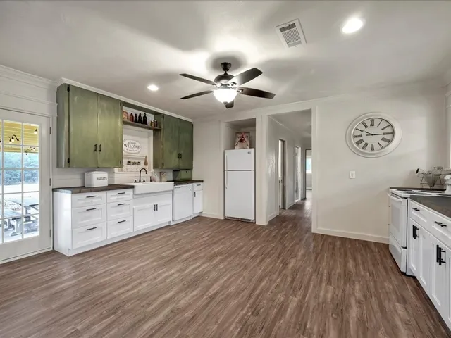 a large room with a lot of kitchen and wooden floor