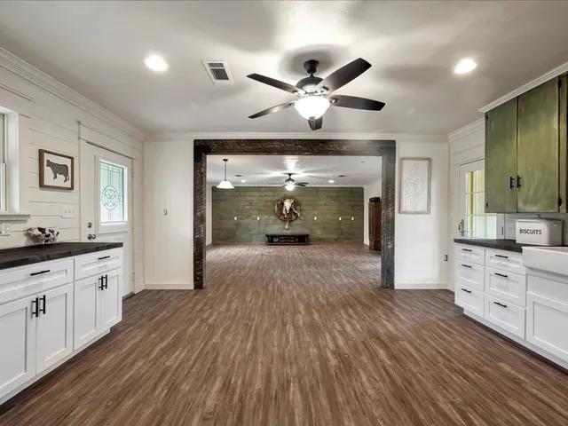 a open kitchen with sink and cabinets