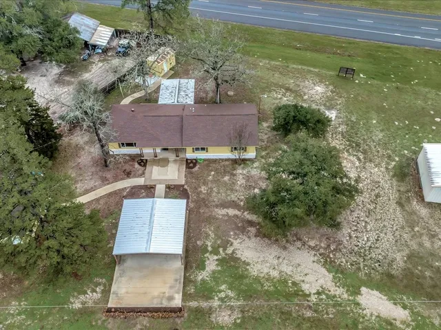 an aerial view of a house with a yard