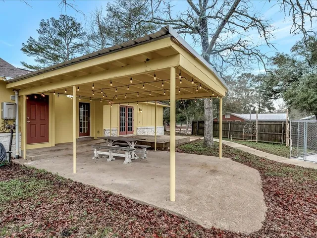 a backyard of a house with garden and outdoor seating