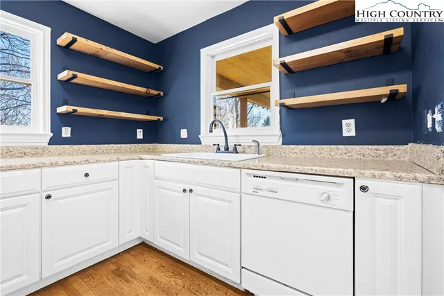 a white refrigerator freezer and a stove sitting inside of a kitchen