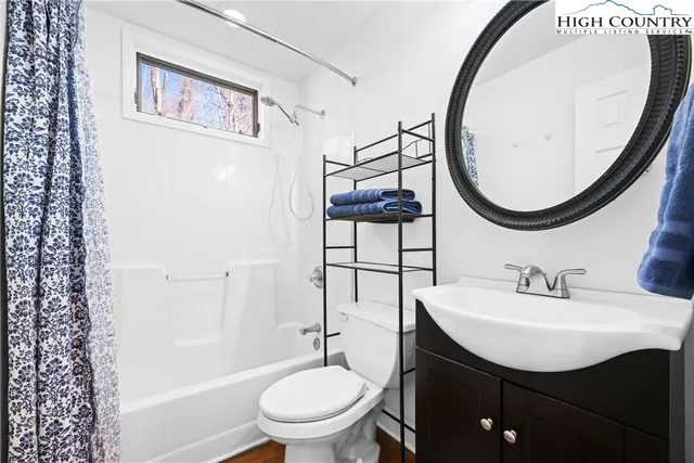 a view of an entryway with wooden floor and door