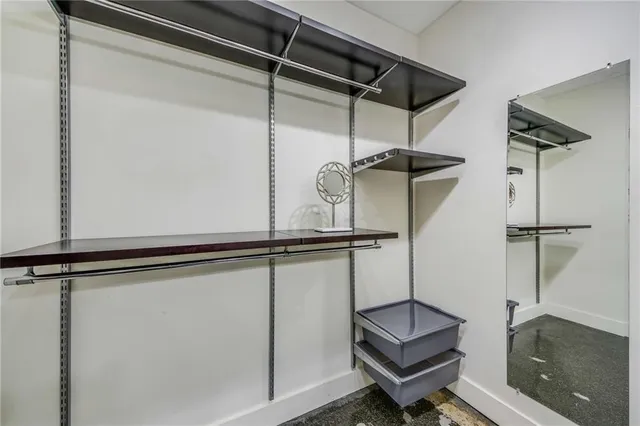 a room with a mirror and a wooden floor