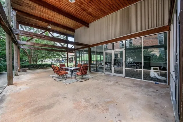 a view of a backyard with table and chairs and a barbeque
