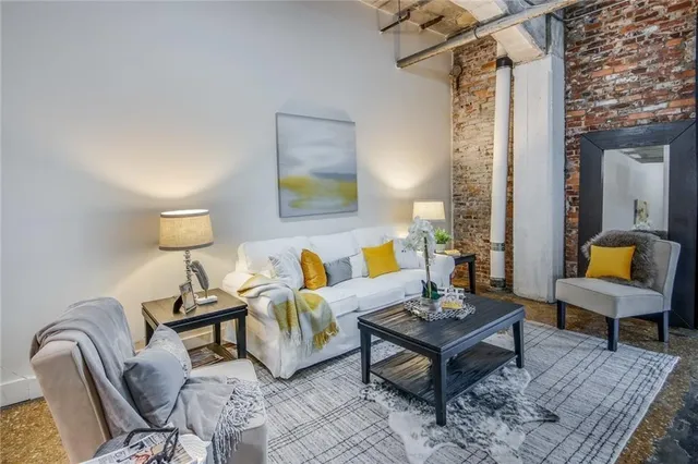 a living room with furniture and a potted plant