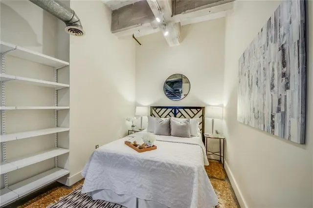 a bedroom with a bed and a wall painting