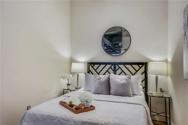 a bedroom with a bed and a painting on the wall