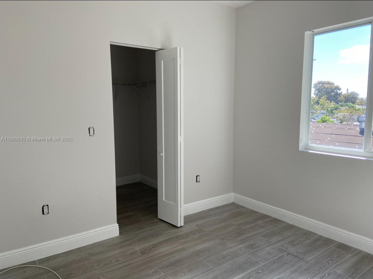 175 East 16th Street, Unit 175 Hialeah, FL 33010 - Photo 15 of 19 a view of an empty room with wooden floor and a window