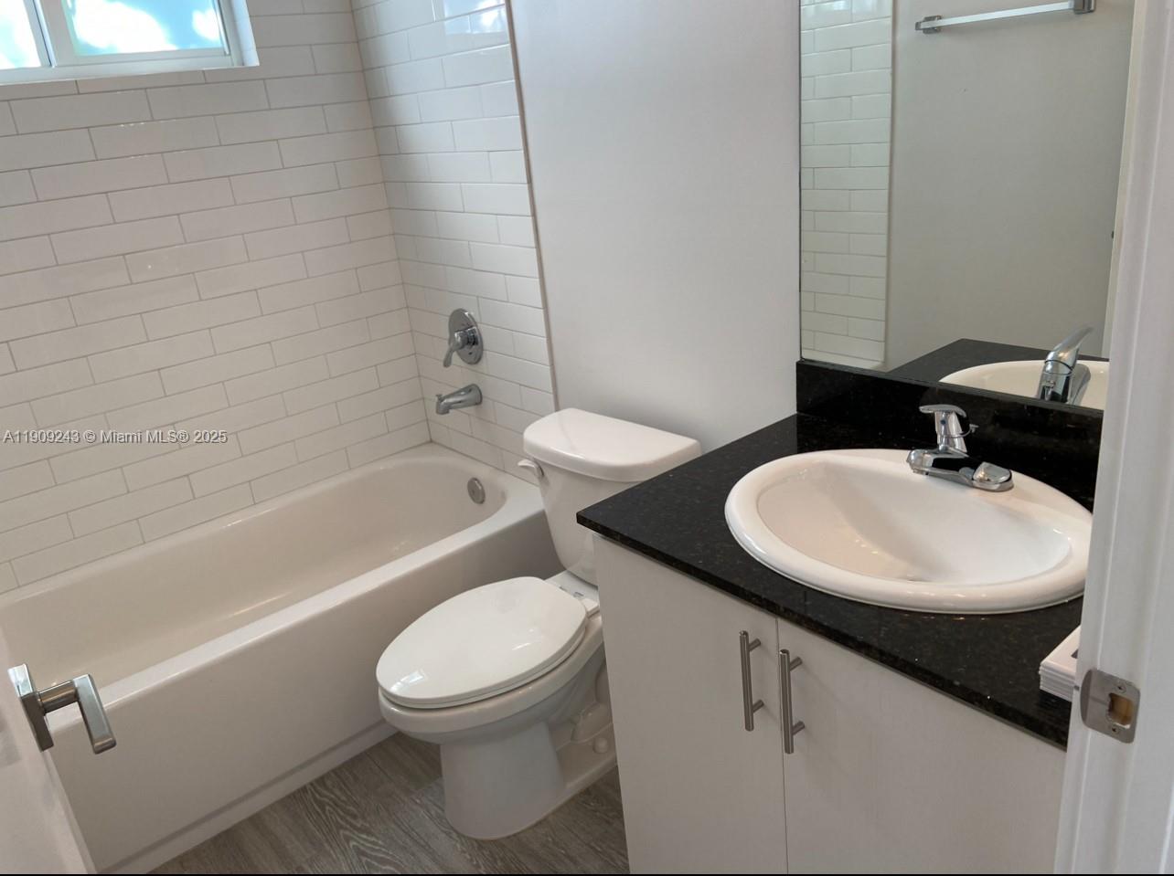 175 East 16th Street, Unit 175 Hialeah, FL 33010 - Photo 16 of 19 a bathroom with a sink a toilet and a bathtub