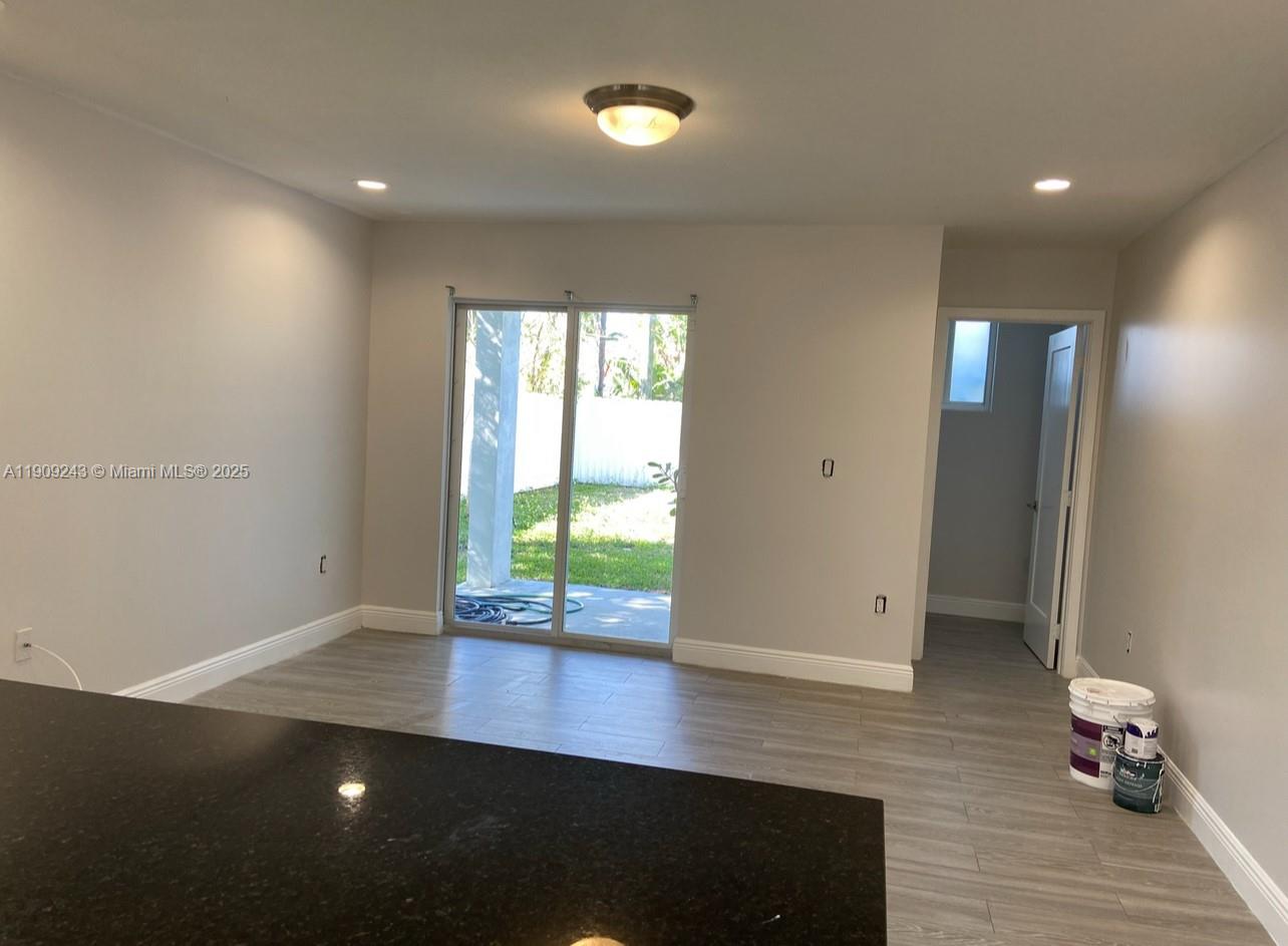 175 East 16th Street, Unit 175 Hialeah, FL 33010 - Photo 2 of 19 an empty room with wooden floor and windows