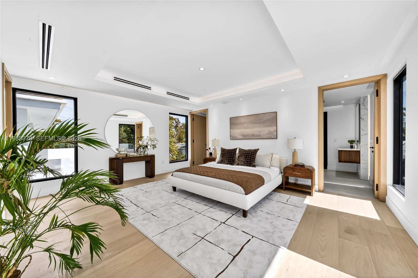 609 Southwest 24th Road Miami, FL 33129 - Photo 23 of 50 a spacious bedroom with a large bed and a potted plant