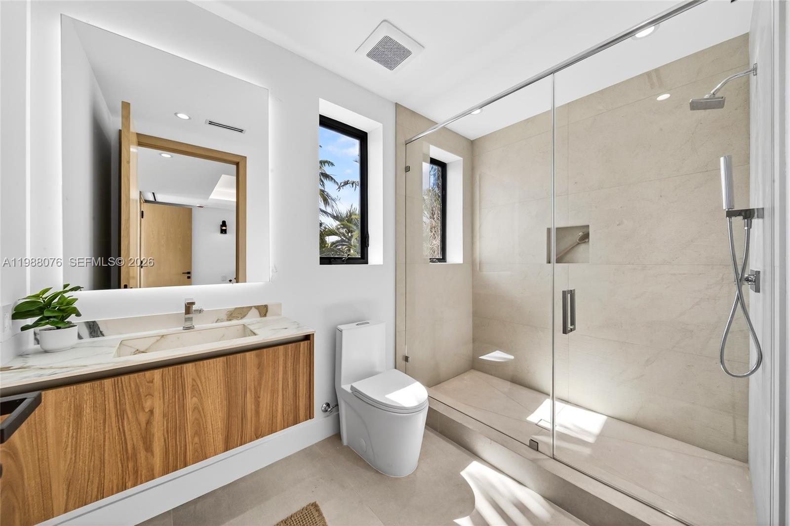 609 Southwest 24th Road Miami, FL 33129 - Photo 31 of 50 a bathroom with a double vanity sink toilet mirror and shower