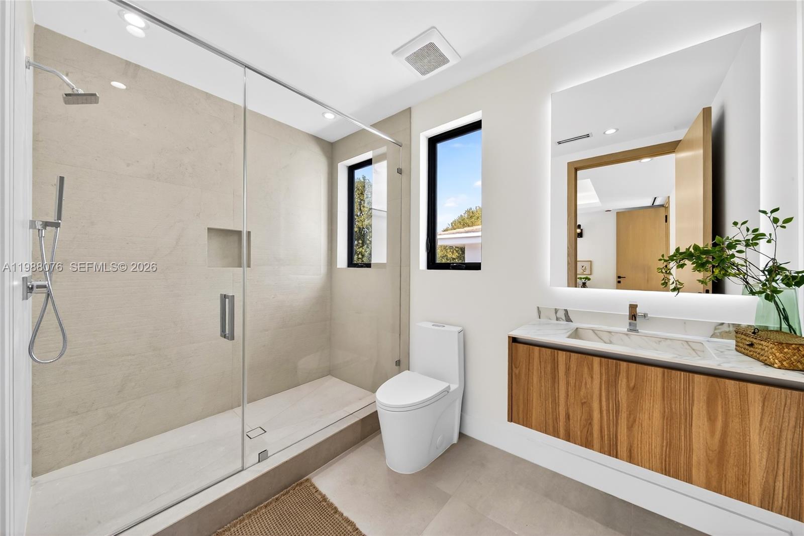 609 Southwest 24th Road Miami, FL 33129 - Photo 35 of 50 a bathroom with a granite countertop sink toilet and shower