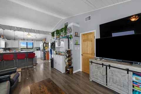 a dining room with furniture and wooden floor