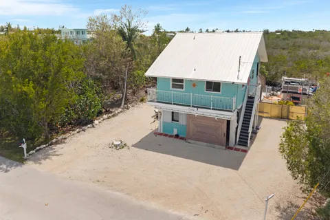 an aerial view of a house with a ocean view