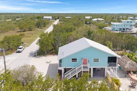 an aerial view of a house with swimming pool and outdoor space