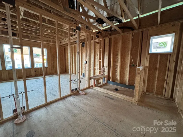 a view of a room with wooden floor and windows