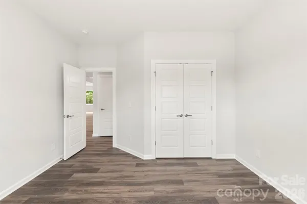 a large bed sitting in a bedroom next to a window