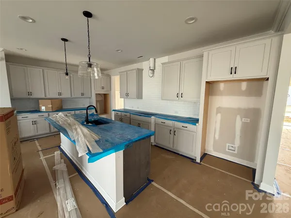 a kitchen with a sink window and cabinets