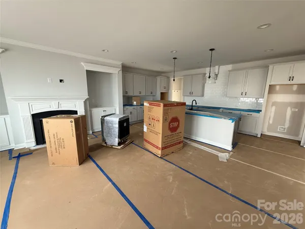 a kitchen with a refrigerator and white cabinets