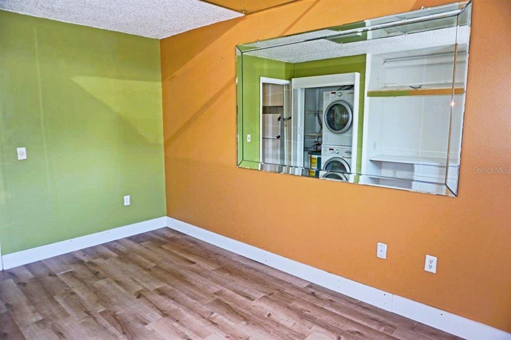 1865 Mazo Manor Road, Unit J5 Lutz, FL 33558 - Photo 14 of 23 a view of a room with wooden floor and a ceiling fan