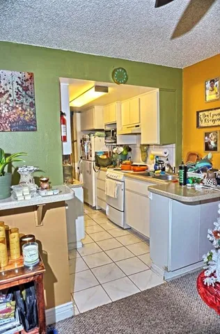 a kitchen with stainless steel appliances kitchen island granite countertop a sink and cabinets