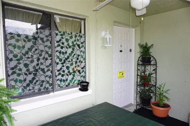 a view of a lake with a building and trees in the background